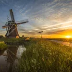 Wooden windmill canal cycling track at sunset