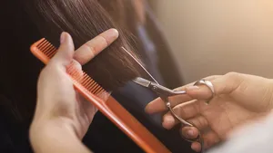 Cropped shot of female client receiving a haircut