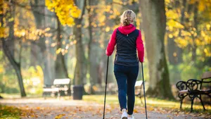 People nordic walking in city park