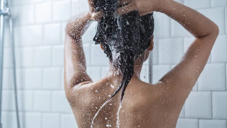 Asian women bathing and she was bathing and washing hair.she is
