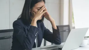 Asian office worker having an eyes tired after overwork