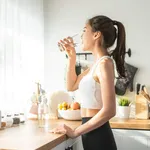 Asian beautiful woman in sportswear drink water after exercise a