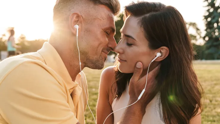Portrait of romantic middle-aged couple man and woman kissing an