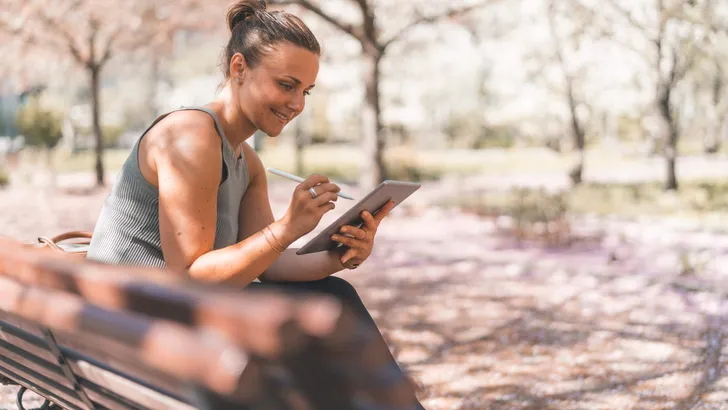 Female Student is Studying in a Cherry Blossom Park