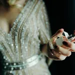 Woman applying perfume