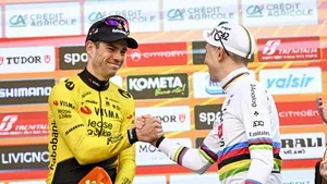 Wout van Aert geeft Tadej Pogacar een hand op het podium van Milaan-Sanremo.