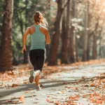 Woman Jogging Outdoors in The Fall