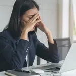 Asian office worker having an eyes tired after overwork