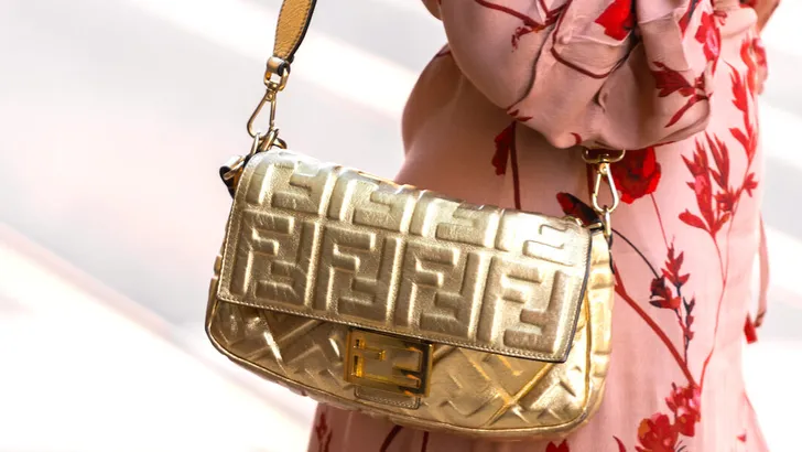 Milan, Italy - September, 22, 2022: woman wearing Fendi Baguette handbag in gold, street style outfit