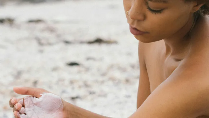 Vrouw smeert zich in met zonnebrandcrème