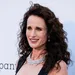 Actrice en model Andie MacDowell met losse krullen en ketting om