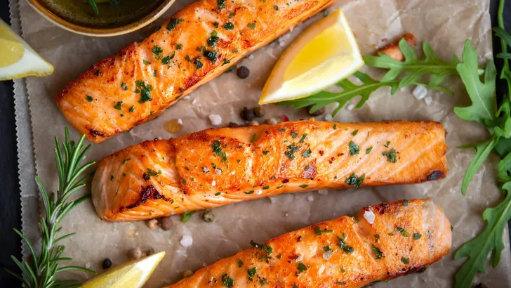 Cooked salmon fish fillet with lemon and rosemary