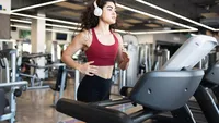 Pretty latin young woman going on a run at the gym