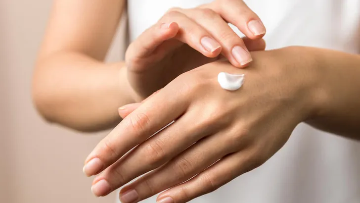 skincare. close up view of woman hand moisturising them with cream. skincare