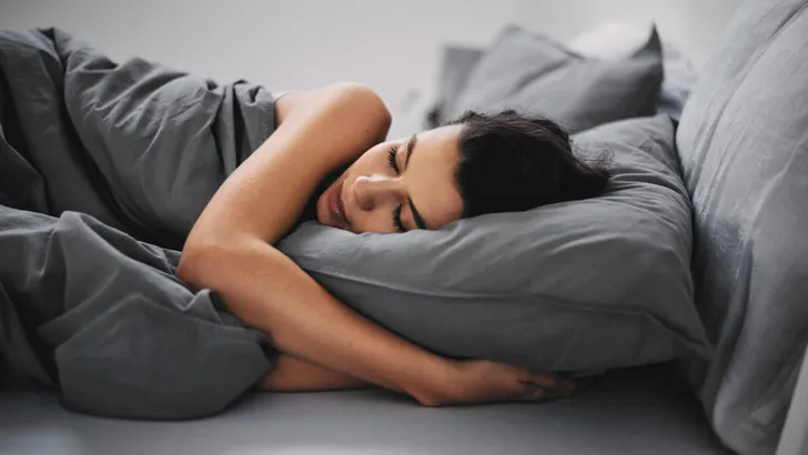 GIrl lying down in bed and sleeping