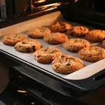 Baking tray with tasty homemade cookies taking out from oven