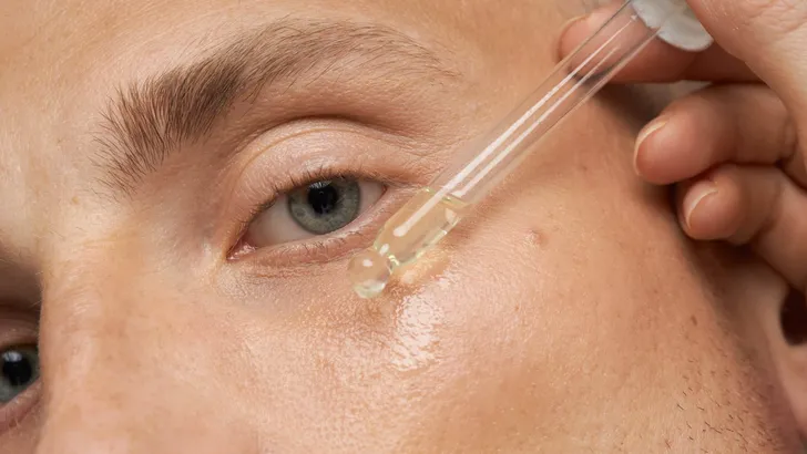 Men's skin care. Close-up facial procedure for a model. Vitamins for the restoration and renewal of the face.